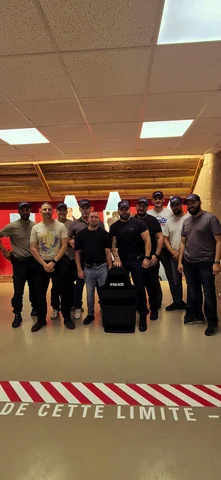 Groupe de stagiaires dans une salle de tir à l'issue d'une session TAP RACK